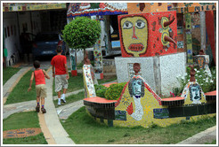Two boys, and red block with yellow face, Fusterlandia.