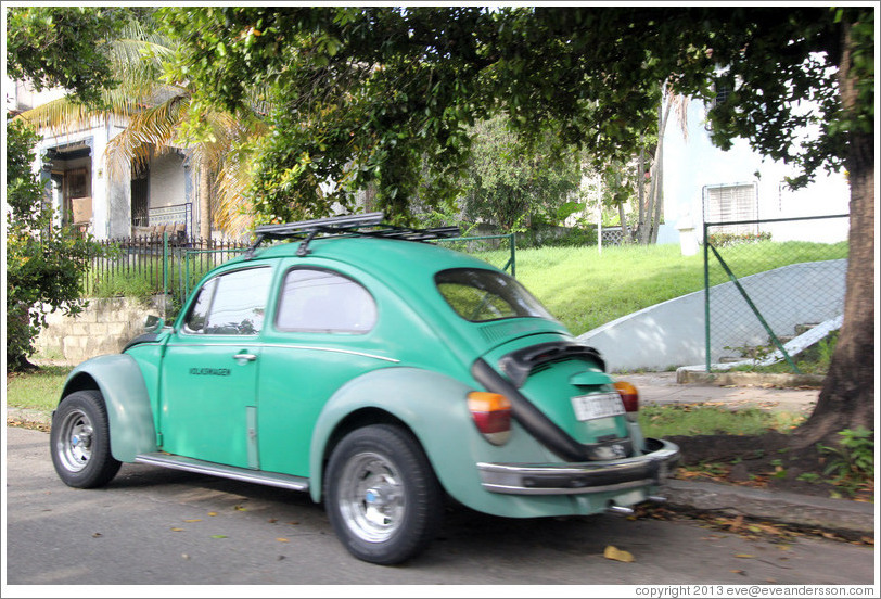 Green Volkswagen Beetle, on a street in Miramar.