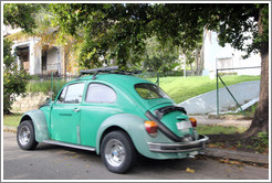 Green Volkswagen Beetle, on a street in Miramar.