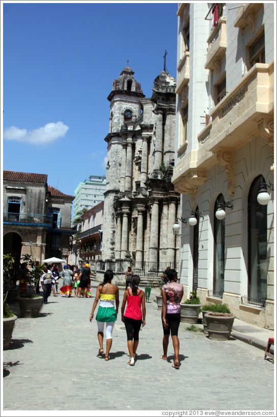 Three women walking down Calle Empedrado, Old Havana.