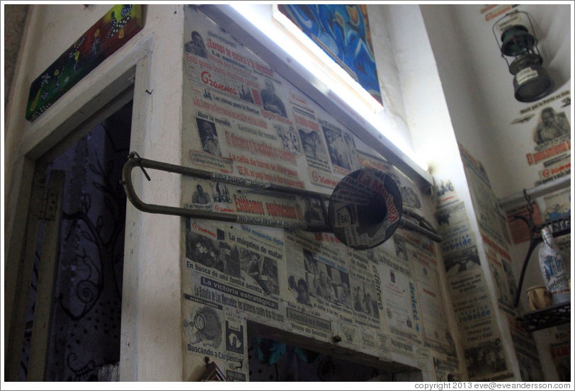 Trombone in front of newspaper clippings, Proyecto Salsita.