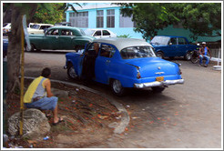 People and a blue car.