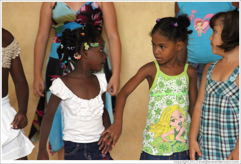 Girls performing, Abraham Lincoln Cultural Center. The girl in green is trying to convince the girl in white to hold hands.