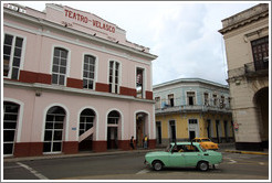 Green car approaching Teatro Velasco near Parque de la Libertad (Liberty Park).