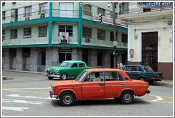 Red car, green car, and dark green car near Parque de la Libertad (Liberty Park).