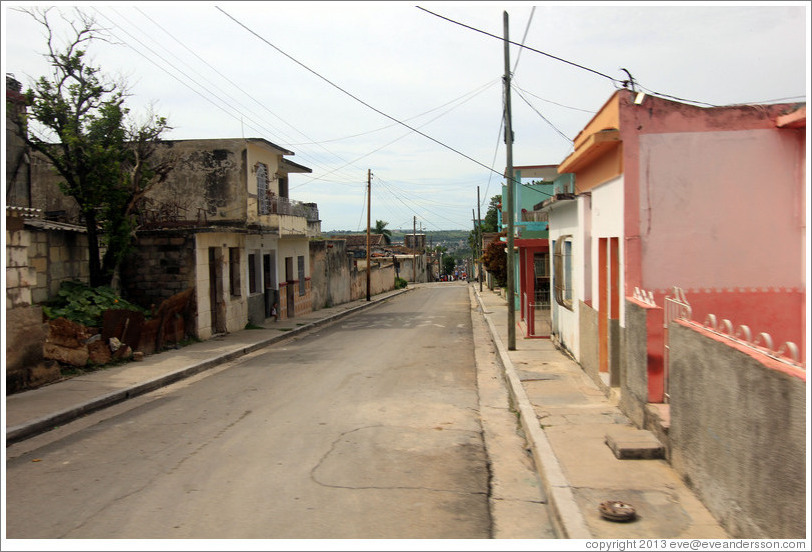 Street with pink and orange house.