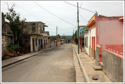 Street with pink and orange house.