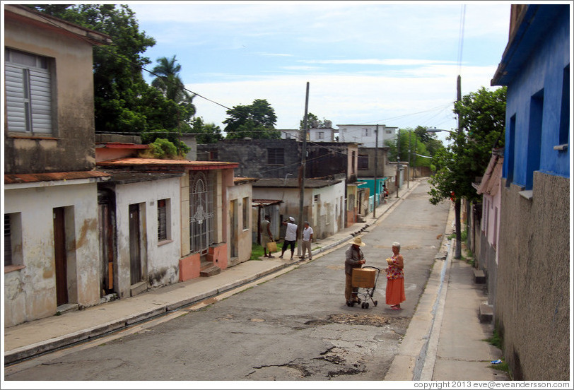 Woman buying something from a vendor in the street.