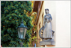 Sculpture of a woman with a wheel and an axe, on the side of a building, Kampa, Mal?trana.