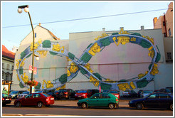 Wall painted with a giant M?bius strip, with alternating tanks and tractors driving on it.  N?dn?Nov?&#283;sto.
