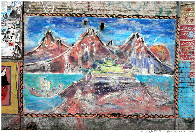 Painting of mountains on a wall.
