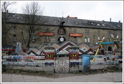 Playground, with eyes painted on fence posts.