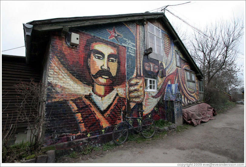 Painting on a wall in Christiania.  Below EZLN (the Zapatista Army of National Liberation), it says (in Spanish), "Viva la autonomia y la libre autodeterminacion de los pueblos del mundo" ("Long live the autonomy and free self-determination of the towns of the world").Pa