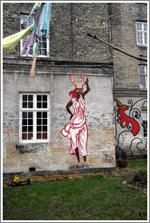 House with painting of a woman carrying a jug that reads "human justice" on her head.