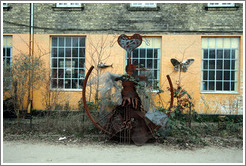 Metal sculpture of a woman with a heart above her head.