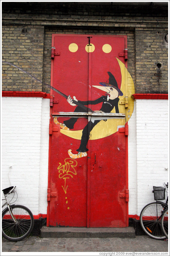 Door of the Moonfisher Cafe, with the three dots symbolizing Christiania at the top.