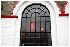 Window of the Moonfisher Cafe, with the Christiania flag hanging behind it.