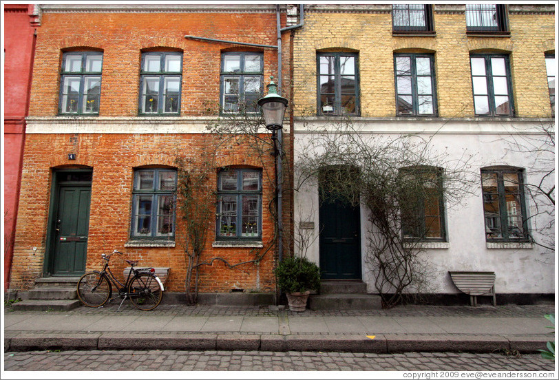 Brick houses, orange, yellow, and off-white.  Neighborhood near Sankt Pauls Kirke, city centre.