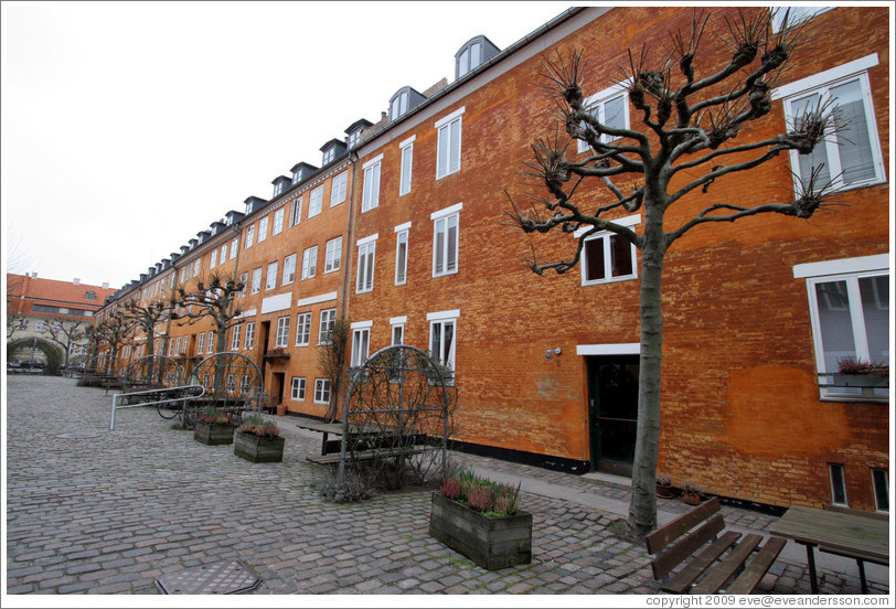 Orange brick housing, with trees.  Neighborhood near Sankt Pauls Kirke, city centre.