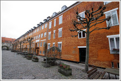 Orange brick housing, with trees.  Neighborhood near Sankt Pauls Kirke, city centre.