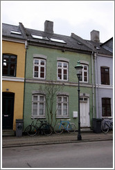 Green house between yellow and blue houses.  Neighborhood near Sankt Pauls Kirke, city centre.