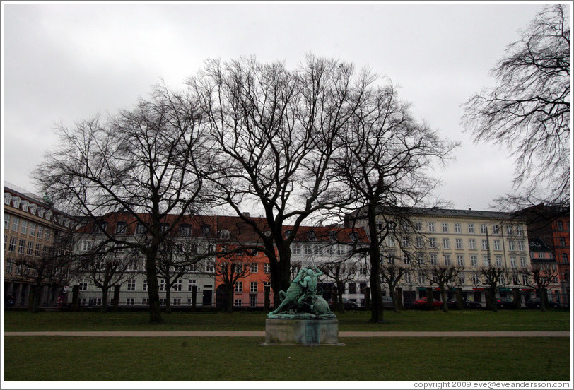 Kongens Have (King's Gardens).  In the distance is Kamp med en slange, a statue by Thomas Brock.  Portrays a Native American attempting to spear a snake that has wrapped itself around his horse.