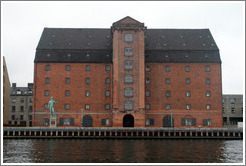 Vestindisk Pakhus, a restored warehouse overlooking Copenhagen harbour.  In front of it stands a replica of Michelangelo's David.
