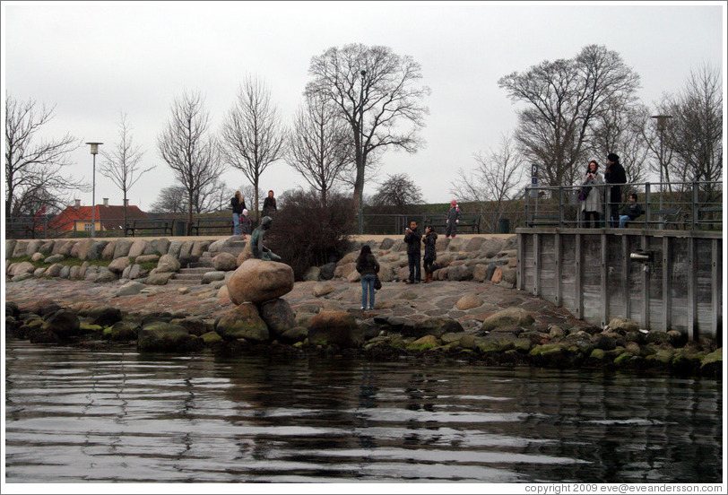 Tourists photographing themselves and The Little Mermaid.  Copenhagen harbour.