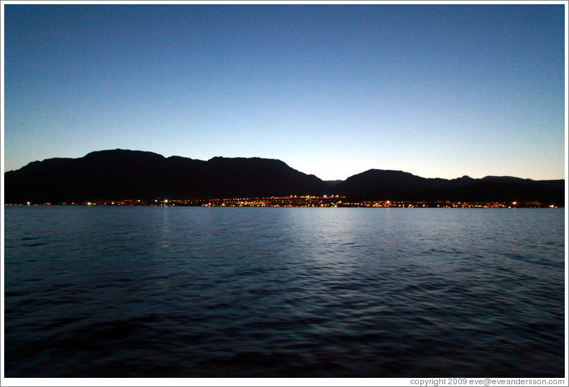 Taba Heights in front of mountains at dusk.