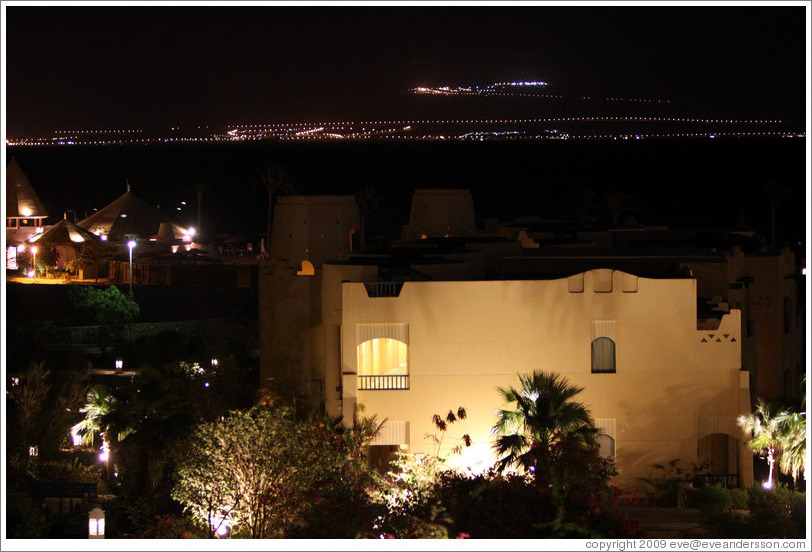 Marriott Hotel at night, with the lights of Jordan in the background.