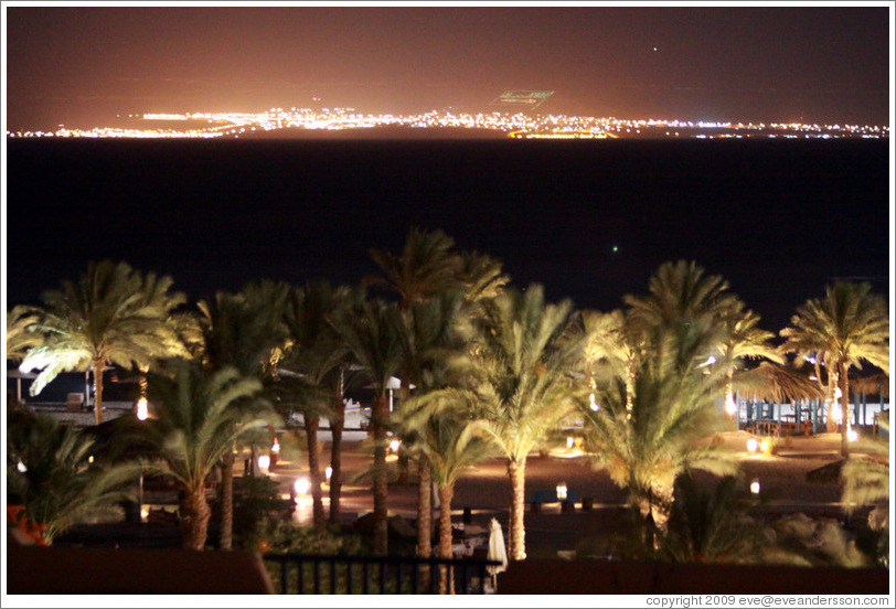 Marriott Hotel at night, with the lights of Saudi Arabia in the background.