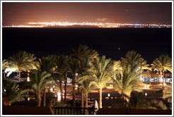 Marriott Hotel at night, with the lights of Saudi Arabia in the background.