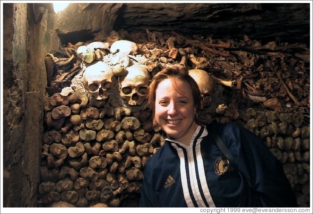 Tracy, looking quite happy to be surrounded by skulls and bones, Paris catacombs.