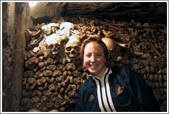 Tracy, looking quite happy to be surrounded by skulls and bones, Paris catacombs.