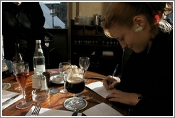 Louvre.  Eve writing postcard.