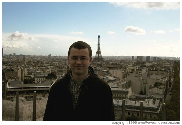 Rolf on top of the Arc de Triomphe, with the Eiffel Tower in the background.