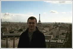 Rolf on top of the Arc de Triomphe, with the Eiffel Tower in the background.