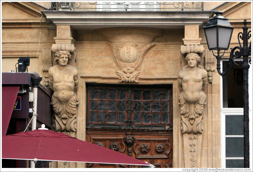 Male and female telamones supporting a balcony.  Place des Pr?eurs.  Old town.