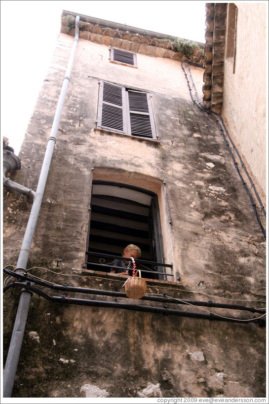 Boy in the window with a bucket.