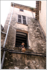 Boy in the window with a bucket.