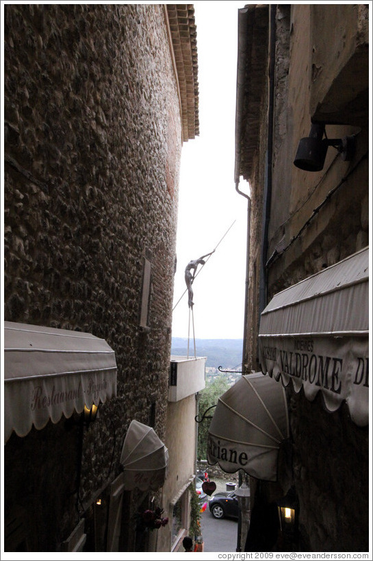 Sculpture of a woman balancing.