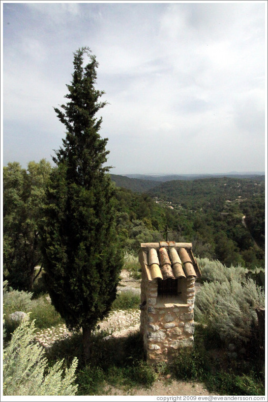 Stone structure and tree outside the town center.