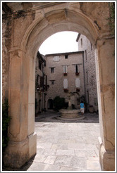 Arch with a fountain behind.