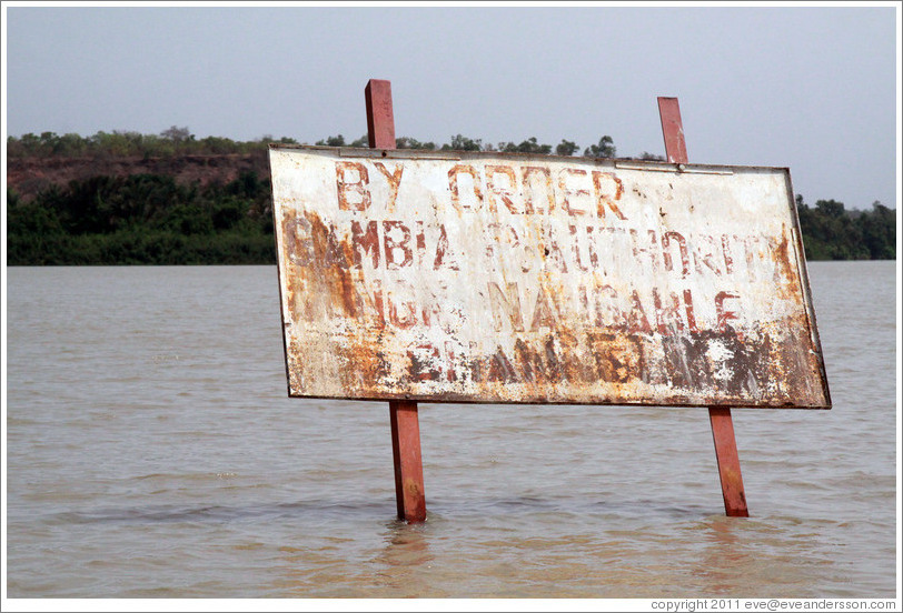 Sign in the River Gambia near Baboon Islands, reading "By order of Gambia P. Authority non-navigable channel."