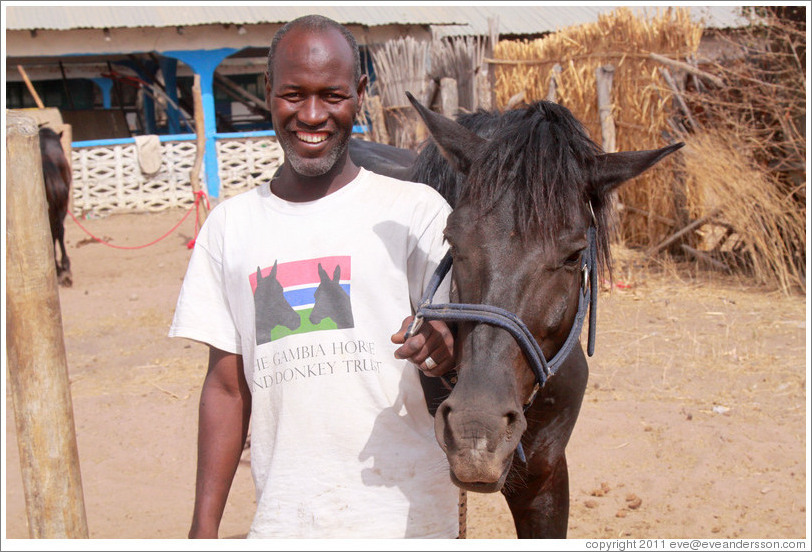 Employee of the Gambia Horse & Donkey Trust with horse named Lazarus.