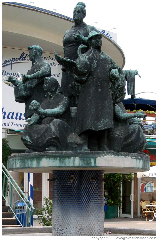 Statue of socialist workers in front of a department store. Alexanderplatz.