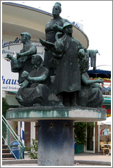 Statue of socialist workers in front of a department store. Alexanderplatz.