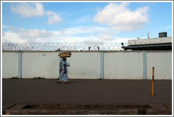 Lady balancing a box on her head.