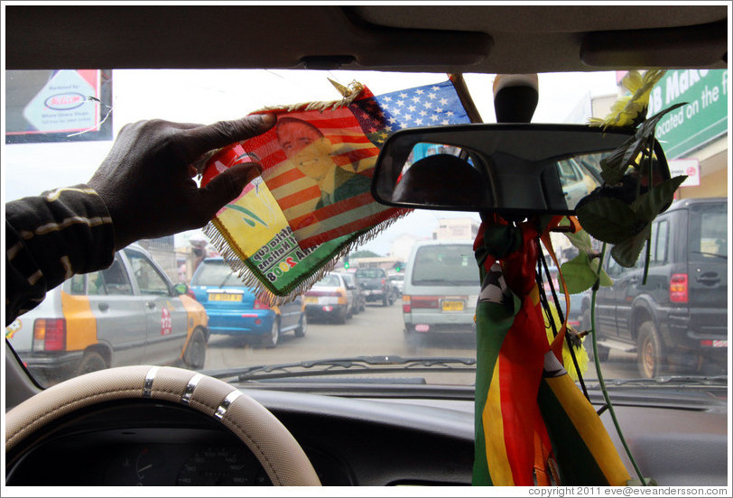 Barack Obama on an American flag, hanging from a taxi driver's rear view mirror.