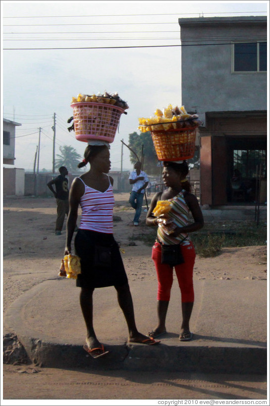 Women with baskets on their heads.